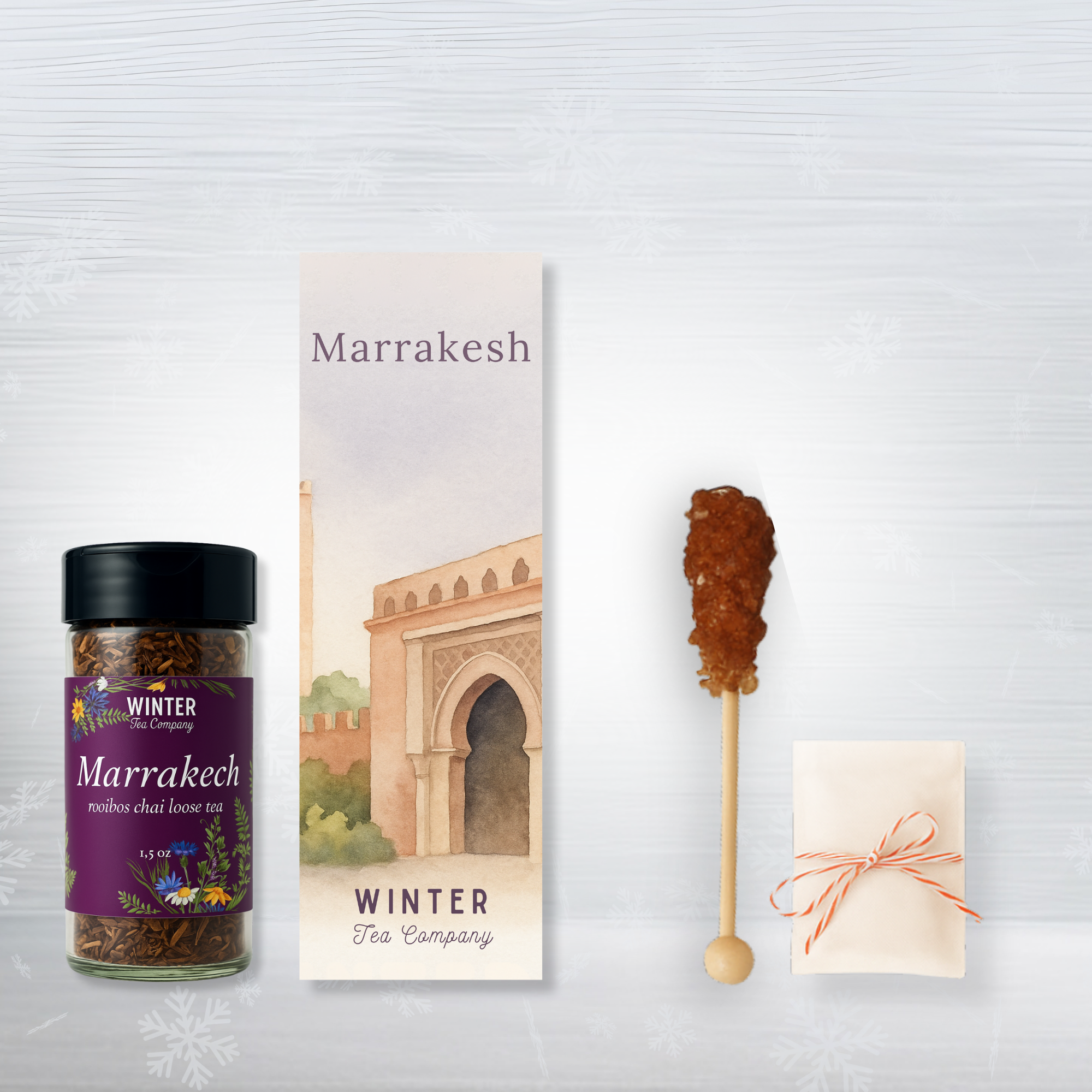Tea packaging with a bottle, book, and decorative items on a light gray background